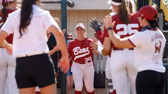 Ashley Prange walking onto the field to high five her teammates