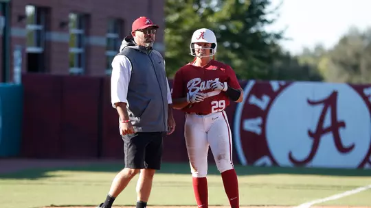 Ashley Prange standing with Coach Murphy on the field