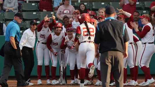 Alabama softball players celebrate at home plate after a home run by Kali Heivilin vs. UAB (March 22, 2023)
