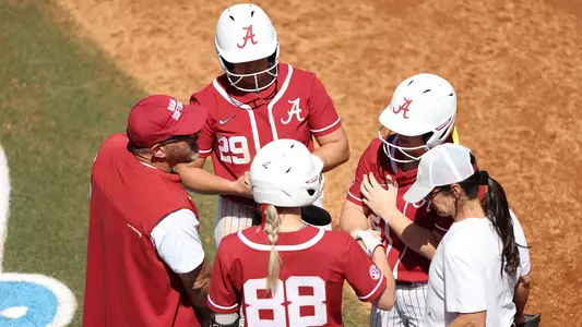 Alabama softball coaches and players huddle during game vs. Tennessee (March 26, 2023)