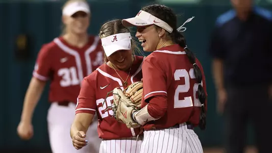 Ashley Prange and Kali Heivilin laugh together after a play on defense vs. Western Michigan (March 7, 2023)