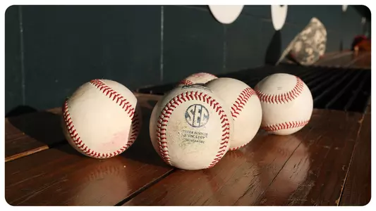 Baseballs sitting on the bench in the dugout