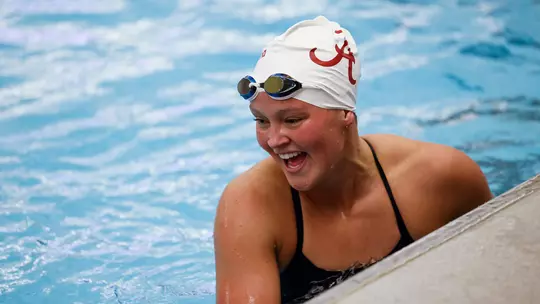Kensey McMahon laughing at the edge of the pool