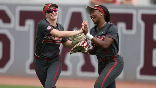 Larissa Preuitt and Kristen White celebrate after a diving catch by Preuitt vs. Mississippi State (April 15, 2023)