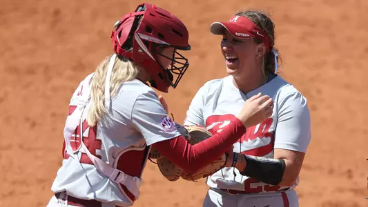 Ashley Prange and Ally Shipman laugh after a play at Mississippi State (April 16, 2023)