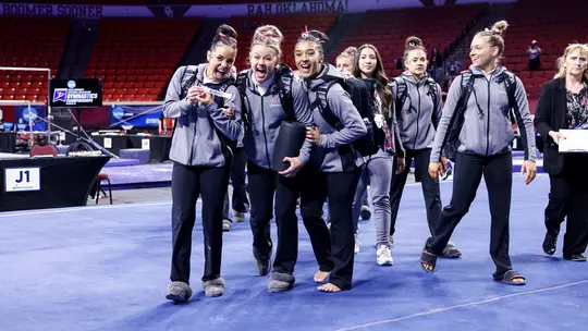 Luisa Blanco posing with her teammates on the floor