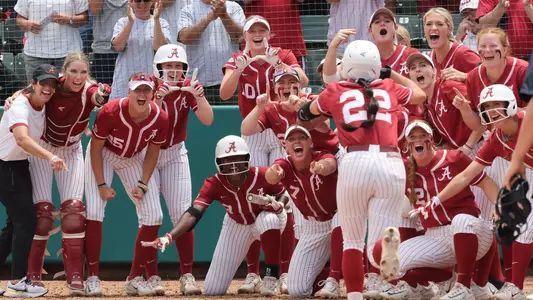 Alabama softball players wait at home plate after a Kali Heivilin home run vs. Middle Tennessee (May 20, 2023)