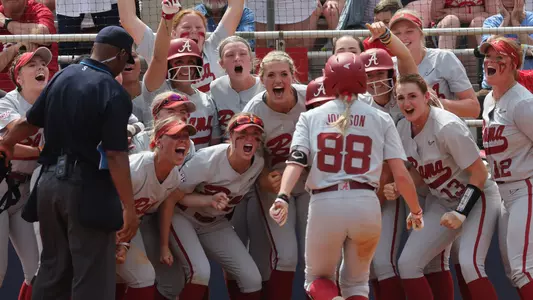Jenna Johnson's teammates await her at home plate after a go-ahead home run vs. Ole Miss (May 6, 2023)