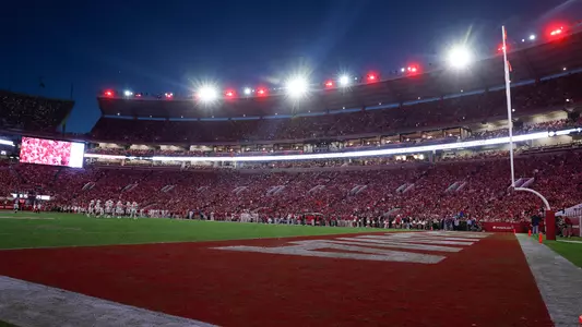Bryant-Denny Stadium during a night game with lights at the top of the stadium lit up