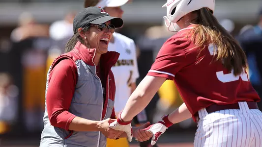 Associate Head Coach Aly Habetz congratulates Kenleigh Cahalan at first base vs. Missouri (April 2, 2023)