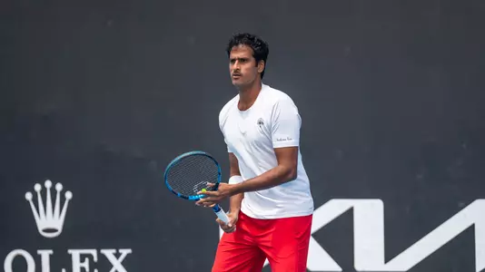 Saketh Myneni waits for a serve