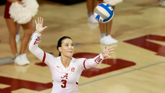 Alabama volleyball player Allison Berent serves the ball.