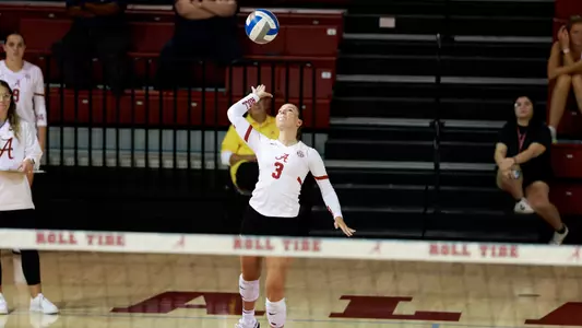Volleyball player Allison Berent hits the ball over the net.