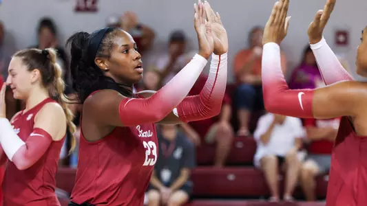 Chaise Campbell high fives teammate Alyiah Wells.