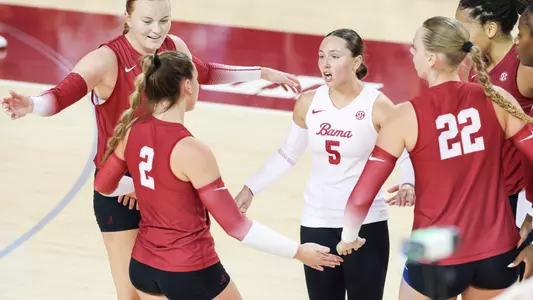 Sydney Gholson joins her team for a group hug.