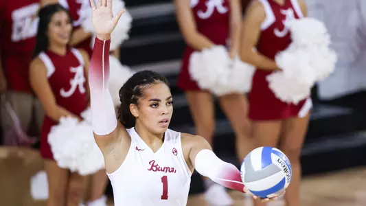 Alabama volleyball player Micah Gryniewicz serves the ball.