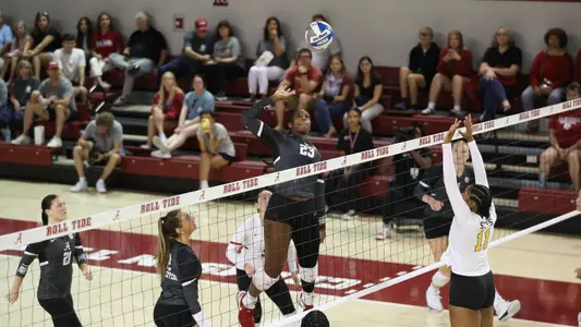 Chaise Campbell tipping the ball at net.