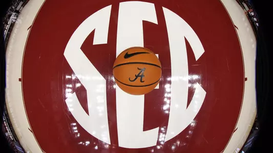 SEC logo printed on the court with a basketball sitting in the center