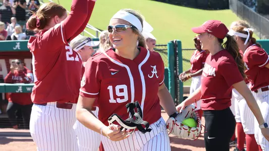 Alabama pitcher Kayla Beaver (19) runs on the field during pregame introductions vs. Shelton State (Oct. 8, 2023)