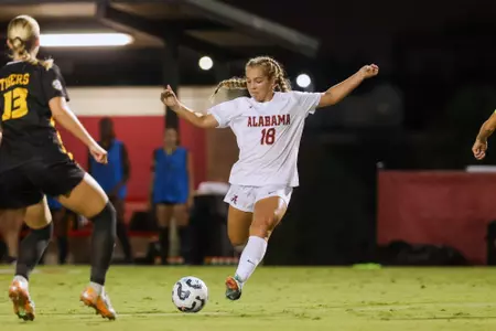 Maddie Padelski kicks the ball