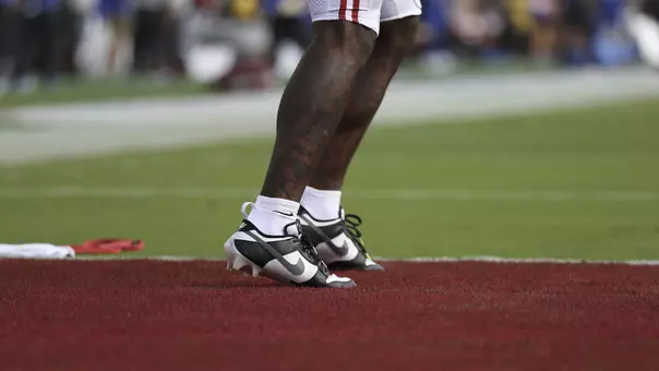 Legs and feet of football player standing in the endzone