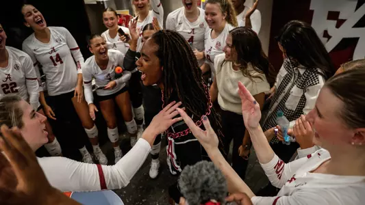 Alabama head volleyball coach Rashinda Reed celebrates with the team in the locker room after beating No. 25 Auburn (Oct. 16, 2024)