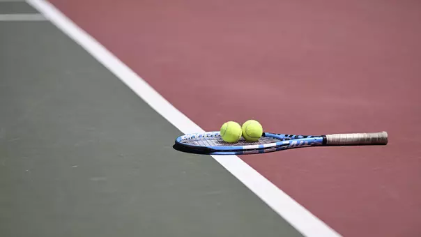 Racket and tennis balls on the court