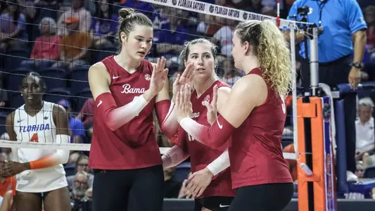 Alabama volleyball players high five on the court vs. Florida (Nov. 10, 2024)