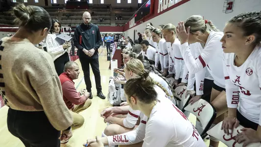 Alabama volleyball coaches speak to players on the bench during a timeout vs. Ole Miss (Nov. 24, 2024)