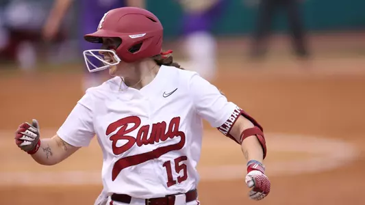 Alabama softball player Kendal Clark smiles on the field.