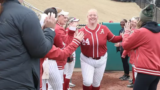 Teammates and coaches cheer on Alabama softball player KJ Haney on her senior day.