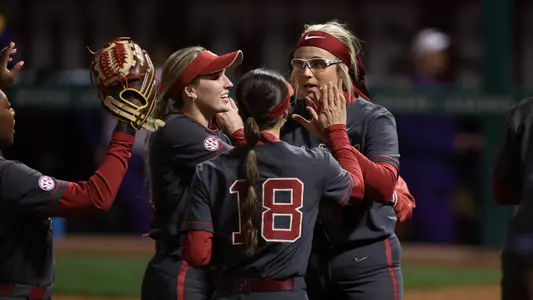 Kayla Beaver (19) celebrates with the outfielders after ending an inning vs. Northern Iowa (Feb. 29, 2024)