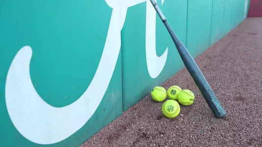 A bat and softballs on the field at Rhoads Stadium (March 10, 2024)