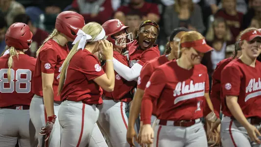 Kali Heivilin (22) and Kristen White (3) celebrate after a Heivilin home run at Florida State (March 13, 2024)