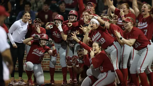 Alabama softball players wait at home to celebrate a home run vs. Florida State (March 13, 2024)