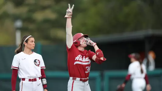 Alabama softball player Marlie Giles reaches base against FSU.