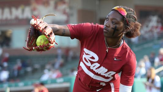 Alabama softball player Kristen White (3) practices catching on the field before the UAB game/