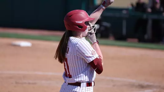 Alabama softball player Kenleigh Cahalan (31) celebrates hitting her first career triple against Virginia Tech.