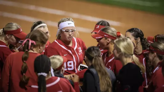 Alabama softball players huddle between innings vs. Virginia Tech (March 22, 2024)