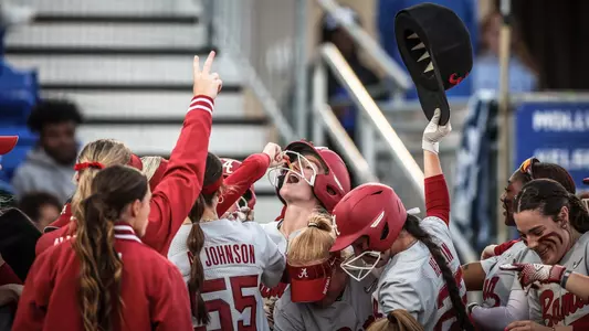 Marlie Giles (34) celebrates with her teammates at home plate after a home run vs. Kentucky (March 29, 2024)