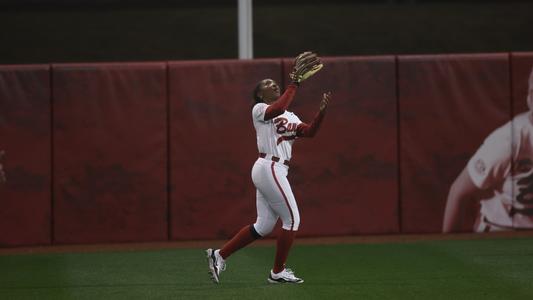 Alabama softball player Kristen White catching a ball in centerfield.