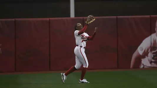 Alabama softball player Kristen White catching a ball in centerfield.