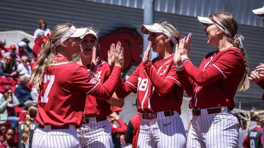 Alabama softball players high five during pregame intros vs. Arkansas (April 21, 2024)