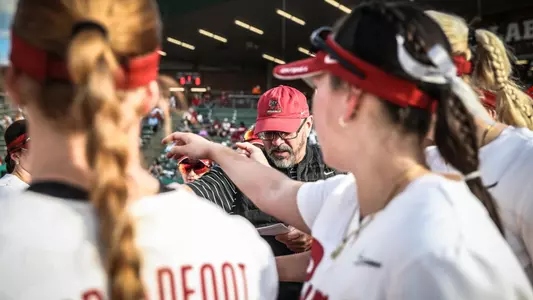 Alabama head softball coach Patrick Murphy leads the pregame huddle vs. Tennessee (April 27, 2024)