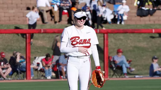 Alabama softball player Larissa Preuitt (11) smiling in right field against Ole Miss.