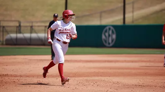Alabama softball player Kendal Clark (15) runs home after hitting a three-run home run.