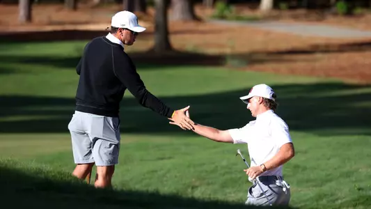 Jonathan Griz is congratulated by assistant coach Forrest Schultz