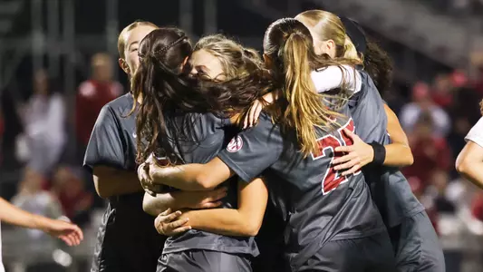 Soccer Team hugging and celebrating