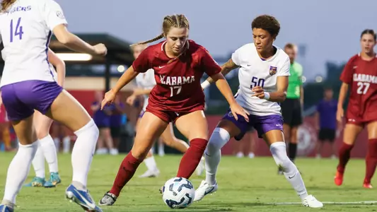 Kate Henderson cuts the ball around a defender