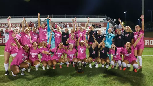 Team celebrates with trophy